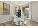 Bright dining room showcasing a glass table, four white chairs, and sliding door with an exterior view at 1756 E Bridgeport Pkwy, Gilbert, AZ 85295