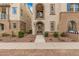 Charming townhome featuring a private balcony and stucco facade with decorative blue tile accents at 1756 E Bridgeport Pkwy, Gilbert, AZ 85295