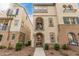 Charming townhome featuring a private balcony and stucco facade with decorative blue tile accents at 1756 E Bridgeport Pkwy, Gilbert, AZ 85295