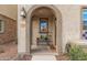 Inviting front porch with potted plants and seating, creating a warm entry to the home at 1756 E Bridgeport Pkwy, Gilbert, AZ 85295