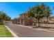 Stone guard house at the entrance of the gated community with paved road and mature trees at 1756 E Bridgeport Pkwy, Gilbert, AZ 85295