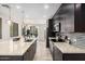 Modern kitchen showcases dark cabinets, stainless appliances, granite counters, and an island with bar seating at 1756 E Bridgeport Pkwy, Gilbert, AZ 85295
