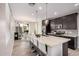 Modern kitchen features a large island with bar seating, granite countertops, and stainless steel appliances at 1756 E Bridgeport Pkwy, Gilbert, AZ 85295