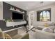 Living room with a gray sofa, floating shelves, a media center, and neutral décor at 1756 E Bridgeport Pkwy, Gilbert, AZ 85295