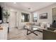 Cozy living room featuring a comfortable sectional sofa, stylish coffee table, and bright natural light at 1756 E Bridgeport Pkwy, Gilbert, AZ 85295