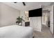 Comfortable bedroom with mounted TV and ensuite bathroom access; features neutral tones at 1756 E Bridgeport Pkwy, Gilbert, AZ 85295