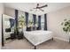 Bright main bedroom showcases large windows, neutral decor, and a full-length mirror at 1756 E Bridgeport Pkwy, Gilbert, AZ 85295