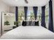 Bright main bedroom showcases large windows, neutral decor, and a full-length mirror at 1756 E Bridgeport Pkwy, Gilbert, AZ 85295