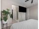 Comfortable bedroom with mounted TV and ensuite bathroom access; features neutral tones at 1756 E Bridgeport Pkwy, Gilbert, AZ 85295