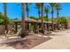 Resort-style pool area with lounge chairs, cabanas, and lush landscaping with palm trees at 1756 E Bridgeport Pkwy, Gilbert, AZ 85295