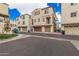 Townhomes with attached garages along a well-maintained street at 1756 E Bridgeport Pkwy, Gilbert, AZ 85295