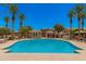 Large community pool with plenty of seating and palm trees offers a refreshing oasis at 1756 E Bridgeport Pkwy, Gilbert, AZ 85295