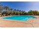 Large swimming pool surrounded by palm trees and lush greenery, perfect for relaxation and recreation at 1756 E Bridgeport Pkwy, Gilbert, AZ 85295