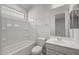 Bathroom featuring a shower-tub combo and a single-sink vanity and mirror for an airy feel at 17637 W Rancho Dr, Litchfield Park, AZ 85340
