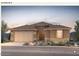 Charming one-story home showcasing a terracotta tile roof, desert landscaping, and a two-car garage at 17637 W Rancho Dr, Litchfield Park, AZ 85340