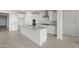 Modern kitchen featuring a large island, stainless appliances, and white cabinets at 17637 W Rancho Dr, Litchfield Park, AZ 85340