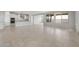 Spacious living room leads to a modern kitchen with white cabinets at 17637 W Rancho Dr, Litchfield Park, AZ 85340