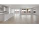 Open-concept living room with expansive windows, seamlessly connecting the kitchen and dining areas at 17637 W Rancho Dr, Litchfield Park, AZ 85340