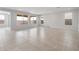 Open concept living room featuring large windows and tile flooring at 17637 W Rancho Dr, Litchfield Park, AZ 85340