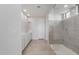 Luxurious main bathroom featuring double sinks, a large glass enclosed shower, and tiled floors at 17637 W Rancho Dr, Litchfield Park, AZ 85340