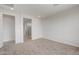 Spacious main bedroom with neutral carpet, leading to a well-lit bathroom area at 17637 W Rancho Dr, Litchfield Park, AZ 85340