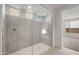 Modern shower featuring a glass enclosure, tiled walls, and multiple shower heads at 17637 W Rancho Dr, Litchfield Park, AZ 85340