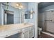 Bathroom featuring a vanity with mirrors, toilet, and a glass-enclosed shower at 17842 N 38Th Dr, Glendale, AZ 85308