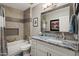 Well-lit bathroom with a shower-tub combo, granite counters, and decorative mirror at 1951 N 64Th St # 69, Mesa, AZ 85205