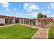Community pool and well manicured grassy area with brick trimmed building in the background at 1951 N 64Th St # 69, Mesa, AZ 85205