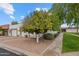 Inviting single-story home showcasing a mature orange tree, a two-car garage, and a neatly landscaped front yard at 1951 N 64Th St # 69, Mesa, AZ 85205