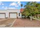 Charming single-story home featuring a red tile roof, well-maintained landscaping, and a two-car garage, a perfect place to call home at 1951 N 64Th St # 69, Mesa, AZ 85205