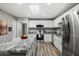 Contemporary kitchen featuring stainless steel appliances, a spacious granite island, and white cabinets, designed for culinary enthusiasts at 1951 N 64Th St # 69, Mesa, AZ 85205