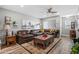 Comfortable living room showcasing leather furniture, a ceiling fan, and tasteful decor, creating an inviting space for relaxation at 1951 N 64Th St # 69, Mesa, AZ 85205