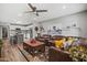 Inviting living room featuring a ceiling fan, plush leather seating, and stylish decor, perfect for relaxation and entertaining at 1951 N 64Th St # 69, Mesa, AZ 85205