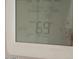 Digital thermostat displaying the indoor temperature of 69 degrees with an outdoor temperature of 44 degrees at 1951 N 64Th St # 69, Mesa, AZ 85205