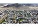 An aerial view of houses in a neighborhood with mountains in the distance and curvilinear streets for traffic calming at 19601 N 14Th St, Phoenix, AZ 85024