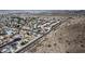 An aerial view of a neighborhood, showing various houses, roads, and desert landscape with mountains in the distance at 19601 N 14Th St, Phoenix, AZ 85024
