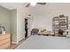 Bedroom with a queen bed, wood-look floors, closet, desk and a view to the hall at 19601 N 14Th St, Phoenix, AZ 85024