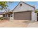 View of the two-car garage and driveway, plus partial desert landscaping around the house at 19601 N 14Th St, Phoenix, AZ 85024