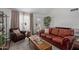 Cozy living room with large leather sofa, a comfortable armchair, and neutral color palette at 19601 N 14Th St, Phoenix, AZ 85024