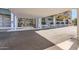 Building entrance with covered portico, glass doors, and lush landscaping at 207 W Clarendon Ave # G18, Phoenix, AZ 85013