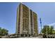 High-rise building with a beige facade and multiple balconies and an American flag at 207 W Clarendon Ave # G18, Phoenix, AZ 85013