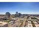 Panoramic city view featuring buildings, parking and distant mountains under clear blue sky at 207 W Clarendon Ave # G18, Phoenix, AZ 85013
