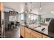 Modern kitchen with black countertops, stainless appliances, and an adjacent dining area with city views at 207 W Clarendon Ave # G18, Phoenix, AZ 85013