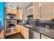 Gourmet kitchen featuring stainless steel appliances, tile backsplash, and ample cabinet space at 207 W Clarendon Ave # G18, Phoenix, AZ 85013