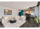 Open-concept living room flows to the kitchen, featuring modern furnishings and city views at 207 W Clarendon Ave # G18, Phoenix, AZ 85013