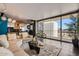 Spacious living room features tile floors, comfortable seating, and large windows with city views at 207 W Clarendon Ave # G18, Phoenix, AZ 85013