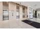 Modern building lobby with marble floors, decorative columns, and stainless steel elevators at 207 W Clarendon Ave # G18, Phoenix, AZ 85013