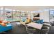 Inviting lounge area with contemporary furniture, large windows, and views of a pool at 207 W Clarendon Ave # G18, Phoenix, AZ 85013