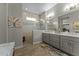 Light and airy bathroom with double sinks, shower, and wood-look floors at 20718 W Colter St, Buckeye, AZ 85396